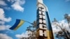 UKRAINE – A Ukrainian national flag flies on an entrance to the town of Kupiansk, liberated by the Ukrainian Armed Forces, amid Russia's attack on Ukraine, in Kharkiv region, September 19, 2022