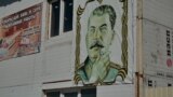 Russia -  A woman carries the portrait of Josef Stalin during the pro-Communist demonstration in Moscow, 01May2007
