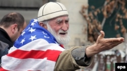 A Georgian demonstrator, known for his affinity for the U.S. flag, attends a 2014 anti-Russia rally in Tbilisi, Georgia.  