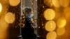 A woman wearing a protective mask is seen through a glass at a shopping centre